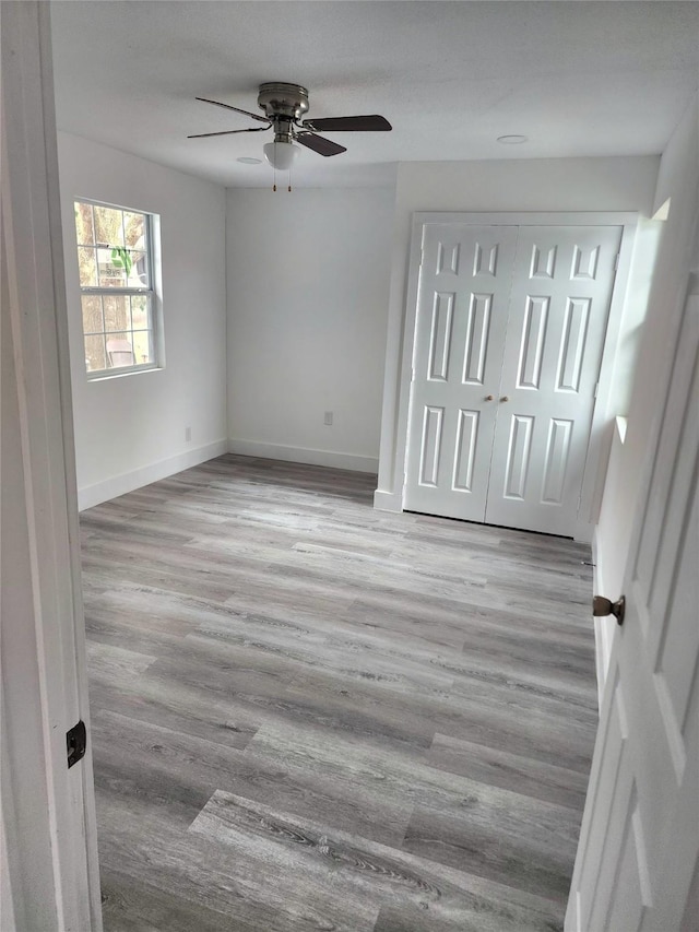 1178 Nob Hill Rd, Quinlan, TX 75474 - unfurnished bedroom featuring wood finished floors, baseboards, ceiling fan, and a closet