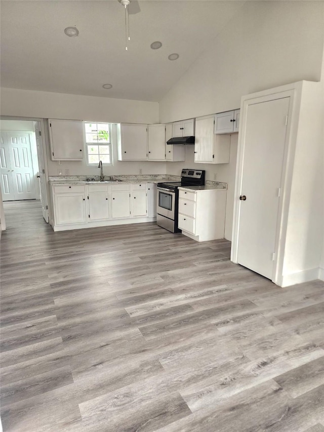 1178 Nob Hill Rd, Quinlan, TX 75474 - kitchen featuring stainless steel electric range, under cabinet range hood, lofted ceiling, white cabinets, and light wood finished floors