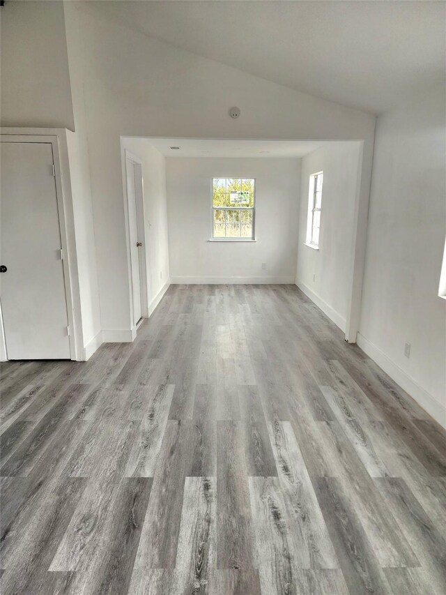 1178 Nob Hill Rd, Quinlan, TX 75474 - empty room featuring wood finished floors, baseboards, and vaulted ceiling