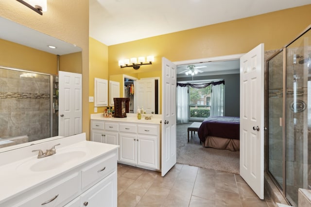 6308 Widgeon Dr, Plano, TX 75024 - full bath with two vanities, a shower stall, tile patterned floors, ensuite bath, and a ceiling fan