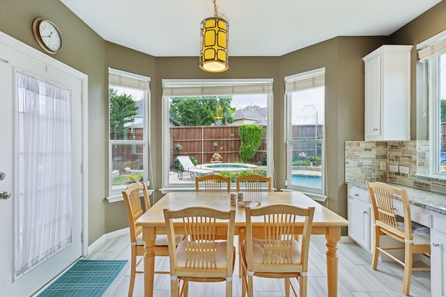6308 Widgeon Dr, Plano, TX 75024 - dining space with plenty of natural light, light wood finished floors, and baseboards