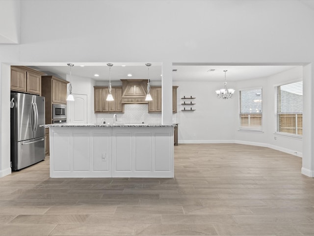 2508 Bunker Hill Dr, Burleson, TX 76028 - kitchen featuring stainless steel appliances, custom exhaust hood, tasteful backsplash, a chandelier, and light wood-style floors