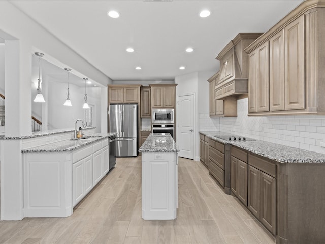 2508 Bunker Hill Dr, Burleson, TX 76028 - kitchen featuring stainless steel appliances, a kitchen island, recessed lighting, a sink, and light stone counters