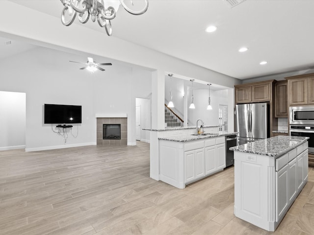 2508 Bunker Hill Dr, Burleson, TX 76028 - kitchen with stainless steel appliances, a sink, a center island, recessed lighting, and a chandelier