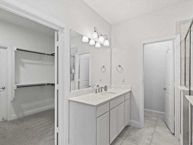 2508 Bunker Hill Dr, Burleson, TX 76028 - bathroom with vanity, a walk in closet, and baseboards