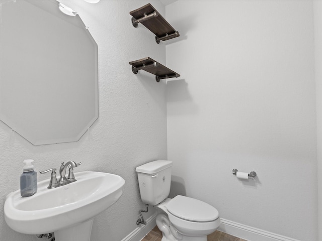 2508 Bunker Hill Dr, Burleson, TX 76028 - half bath featuring a sink, toilet, baseboards, and wood finished floors