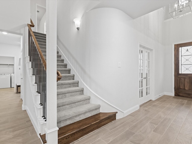 2508 Bunker Hill Dr, Burleson, TX 76028 - foyer entrance with washer and dryer, stairway, light wood-style floors, baseboards, and a high ceiling