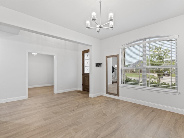 2508 Bunker Hill Dr, Burleson, TX 76028 - unfurnished room featuring a chandelier, light wood-type flooring, and baseboards