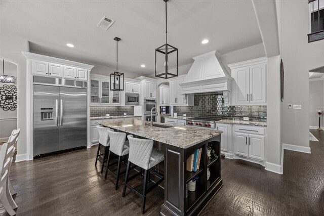 8249 Treemont Pl, Frisco, TX 75034 - kitchen with built in appliances, a sink, custom exhaust hood, tasteful backsplash, and recessed lighting