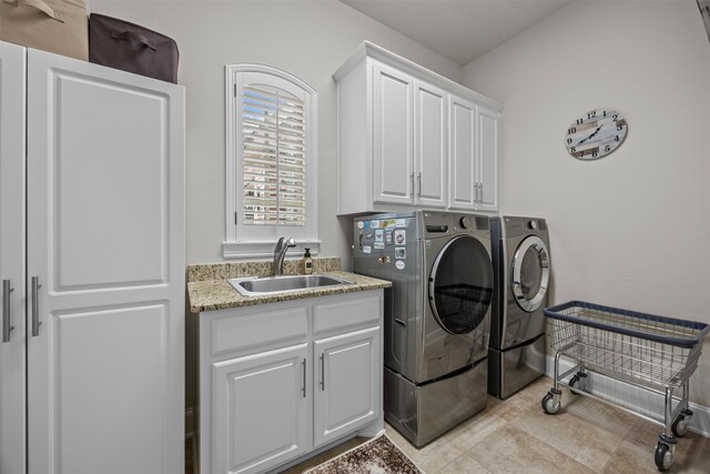 8249 Treemont Pl, Frisco, TX 75034 - laundry area featuring washing machine and clothes dryer, cabinet space, and baseboards