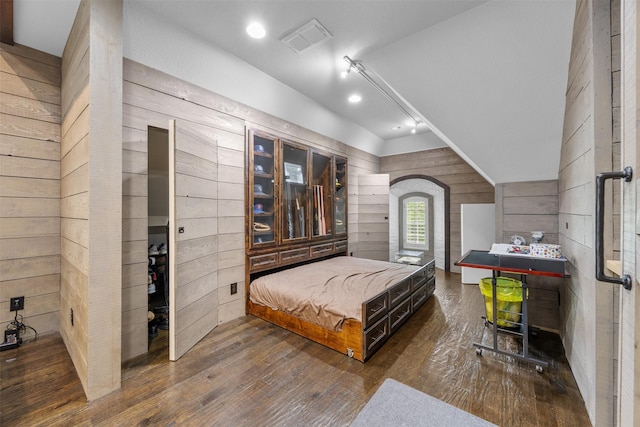 8249 Treemont Pl, Frisco, TX 75034 - bedroom with dark wood finished floors, vaulted ceiling, wooden walls, and recessed lighting