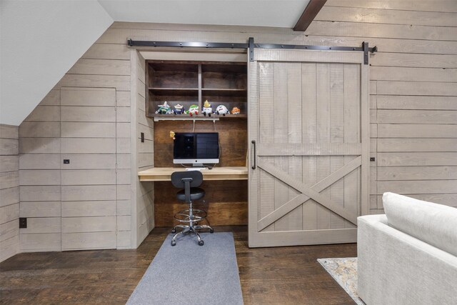 8249 Treemont Pl, Frisco, TX 75034 - office space with a barn door, wood finished floors, wooden walls, built in desk, and lofted ceiling