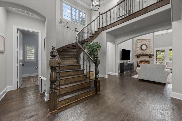 8249 Treemont Pl, Frisco, TX 75034 - staircase with baseboards, plenty of natural light, a high ceiling, wood finished floors, and a fireplace