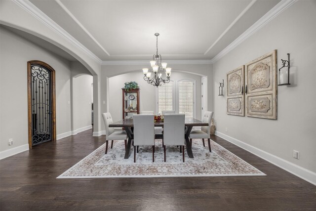 8249 Treemont Pl, Frisco, TX 75034 - dining space with arched walkways, a chandelier, dark wood-style flooring, baseboards, and crown molding