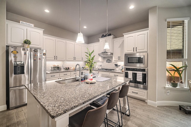 117 Welch Folly Ln, Aledo, TX 76008 - kitchen featuring appliances with stainless steel finishes, light stone counters, white cabinetry, decorative backsplash, and recessed lighting
