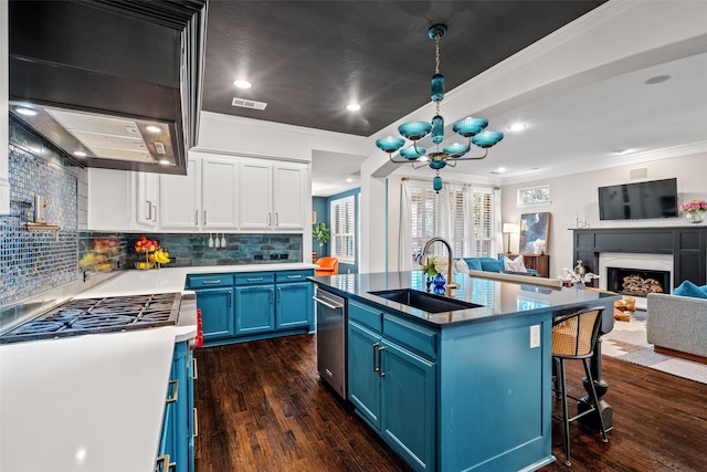 7905 Strathmill Dr, The Colony, TX 75056 - kitchen with blue cabinets, a sink, stainless steel appliances, open floor plan, and white cabinetry