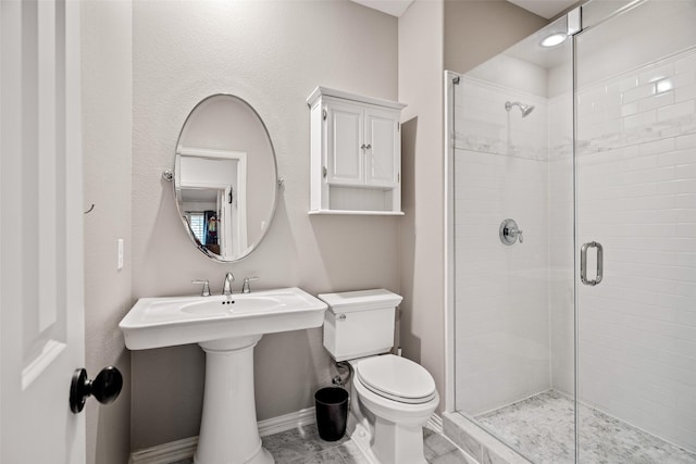 7905 Strathmill Dr, The Colony, TX 75056 - bathroom featuring toilet, a stall shower, and baseboards