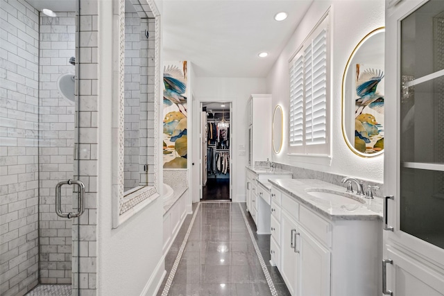 7905 Strathmill Dr, The Colony, TX 75056 - bathroom with a shower stall, double vanity, a spacious closet, and recessed lighting
