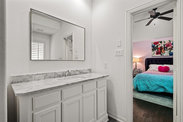 7905 Strathmill Dr, The Colony, TX 75056 - bathroom with wood finished floors, vanity, a ceiling fan, and ensuite bathroom