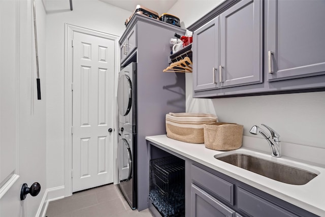 7905 Strathmill Dr, The Colony, TX 75056 - laundry area featuring cabinet space, stacked washer / dryer, and light tile patterned floors