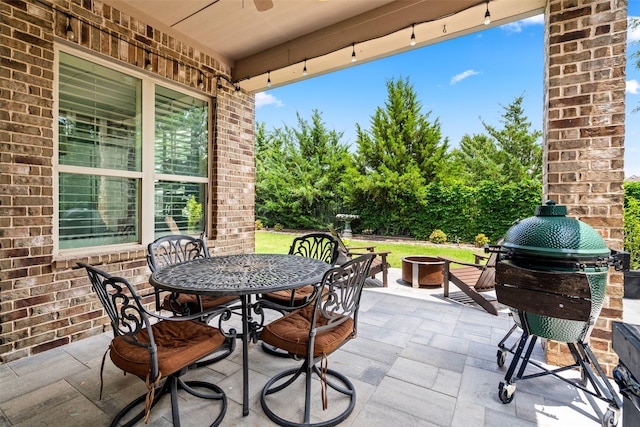 7905 Strathmill Dr, The Colony, TX 75056 - view of patio / terrace with a fire pit, outdoor dining space, and a ceiling fan