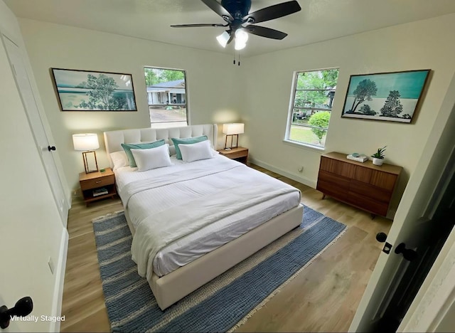 126 Stephens St, Waxahachie, TX 75165 - bedroom with multiple windows, light wood-style floors, baseboards, and ceiling fan