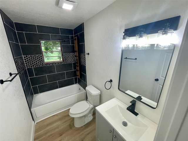 126 Stephens St, Waxahachie, TX 75165 - full bath featuring wood finished floors, toilet, a textured wall, tub / shower combination, and vanity