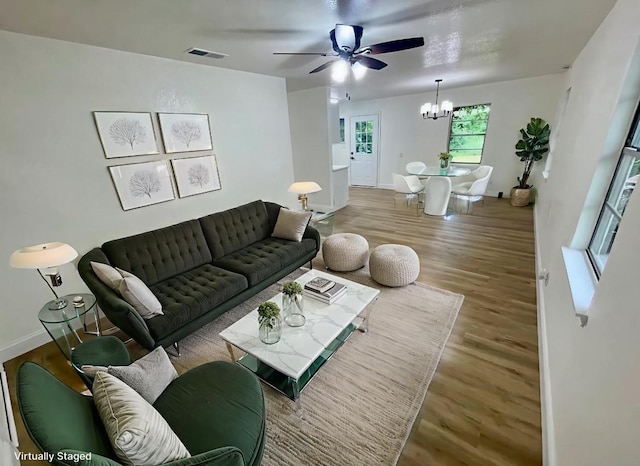 126 Stephens St, Waxahachie, TX 75165 - living room featuring wood finished floors, a chandelier, a ceiling fan, and baseboards