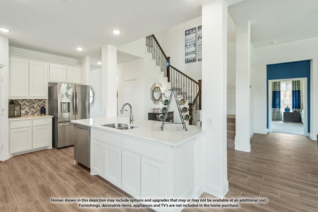 3418 Abingdon Dr, Melissa, TX 75454 - kitchen featuring a sink, stainless steel appliances, light wood-style flooring, light countertops, and decorative backsplash