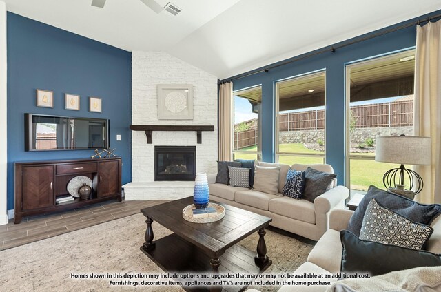 3418 Abingdon Dr, Melissa, TX 75454 - living room featuring lofted ceiling, wood tiled floors, a ceiling fan, and a fireplace