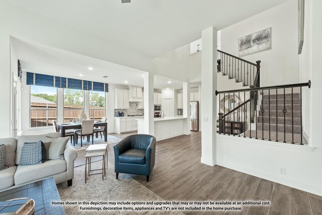 3418 Abingdon Dr, Melissa, TX 75454 - living room featuring stairs, wood finished floors, baseboards, and recessed lighting