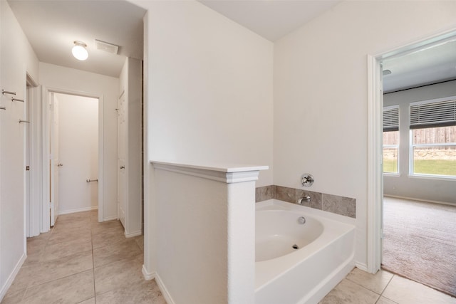 1503 E Collins Blvd, Wylie, TX 75098 - bathroom with tile patterned flooring, a garden tub, and baseboards