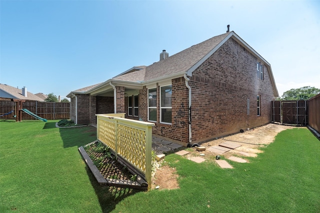 1503 E Collins Blvd, Wylie, TX 75098 - back of property featuring brick siding, a playground, a chimney, and roof with shingles