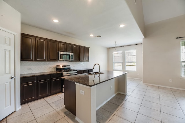 1503 E Collins Blvd, Wylie, TX 75098 - kitchen with appliances with stainless steel finishes, a sink, light tile patterned flooring, tasteful backsplash, and dark stone countertops