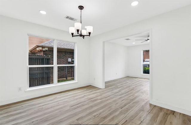 783 Eiffel Dr, Plano, TX 75023 - spare room featuring a chandelier, wood finished floors, baseboards, and recessed lighting