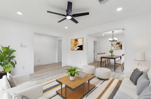 783 Eiffel Dr, Plano, TX 75023 - living room with light wood-style floors, recessed lighting, ceiling fan, a chandelier, and baseboards