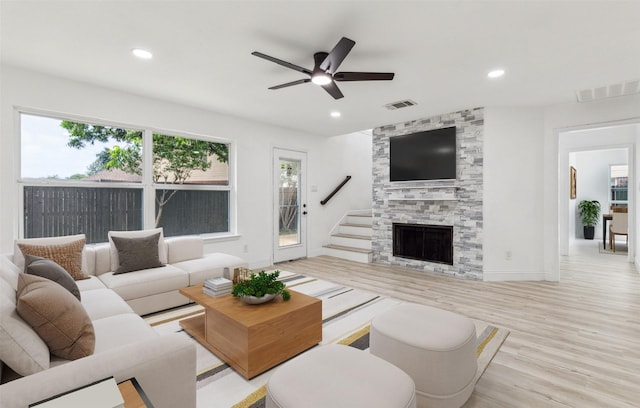 783 Eiffel Dr, Plano, TX 75023 - living area with plenty of natural light, light wood finished floors, ceiling fan, recessed lighting, and a stone fireplace