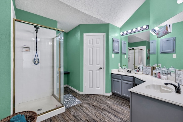 1908 Timberline Ln, Sherman, TX 75092 - full bath with a shower stall, double vanity, wood finished floors, a textured ceiling, and lofted ceiling