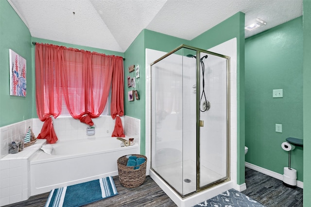 1908 Timberline Ln, Sherman, TX 75092 - bathroom featuring wood finished floors, a bath, a shower stall, toilet, and a textured ceiling