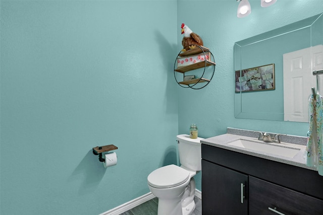 1908 Timberline Ln, Sherman, TX 75092 - bathroom featuring toilet, vanity, and baseboards