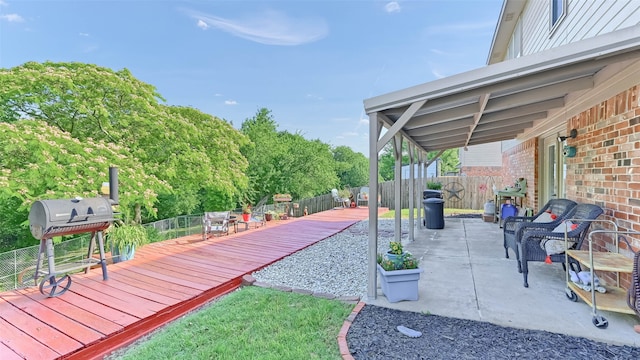 1908 Timberline Ln, Sherman, TX 75092 - fenced backyard with a wooden deck, a patio area, and view of wooded area