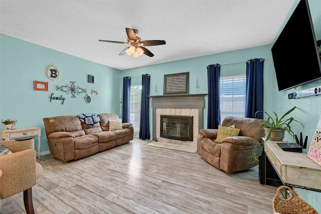 1908 Timberline Ln, Sherman, TX 75092 - living area featuring plenty of natural light, ceiling fan, a tile fireplace, and light wood-type flooring