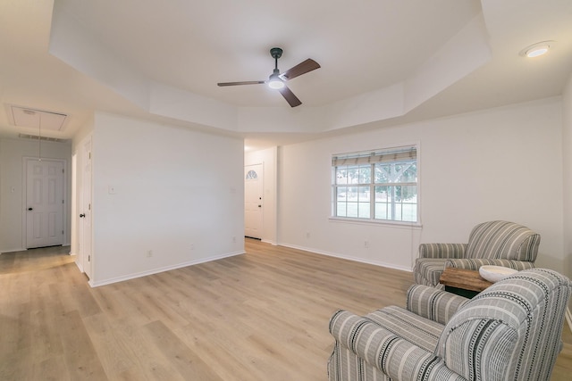 1503 County Road 705, Joshua, TX 76058 - living area with attic access, ceiling fan, light wood-type flooring, baseboards, and a raised ceiling
