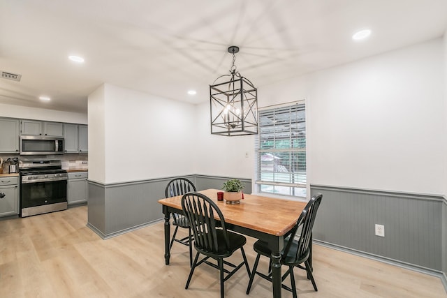 1503 County Road 705, Joshua, TX 76058 - dining space featuring wainscoting, light wood finished floors, recessed lighting, and a chandelier