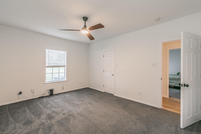 1503 County Road 705, Joshua, TX 76058 - unfurnished room featuring ceiling fan, dark colored carpet, a smoke detector, and baseboards