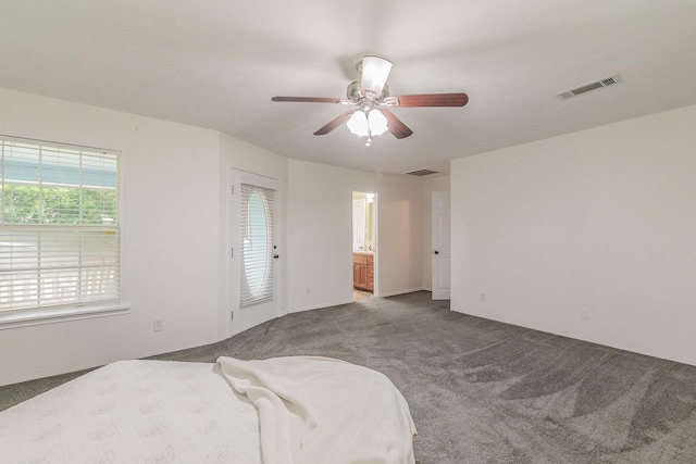 1503 County Road 705, Joshua, TX 76058 - carpeted bedroom with ensuite bathroom and ceiling fan