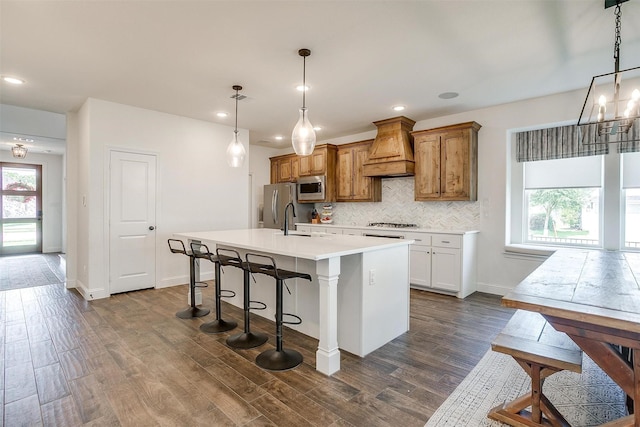 9925 Chaparral Pass, Fort Worth, TX 76126 - kitchen featuring stainless steel appliances, custom exhaust hood, a kitchen island with sink, a chandelier, and tasteful backsplash