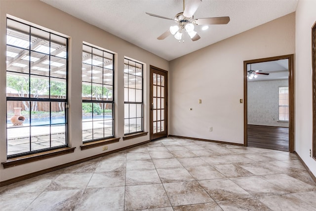 1504 Huron Trl, Plano, TX 75075 - spare room featuring a ceiling fan, baseboards, a textured ceiling, lofted ceiling, and light tile patterned flooring