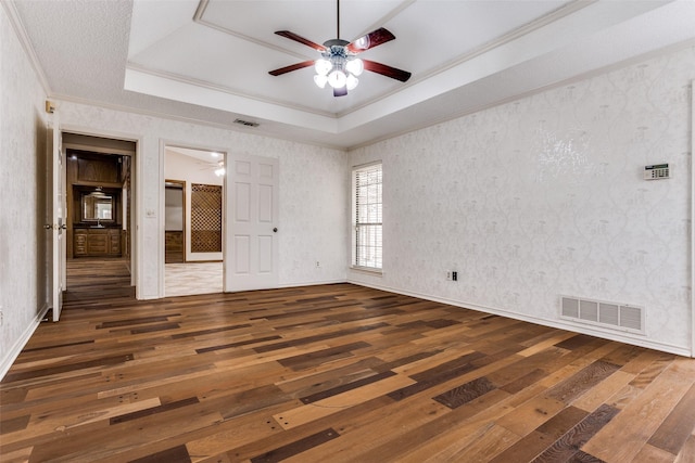 1504 Huron Trl, Plano, TX 75075 - unfurnished bedroom with a tray ceiling, crown molding, hardwood / wood-style flooring, and a ceiling fan