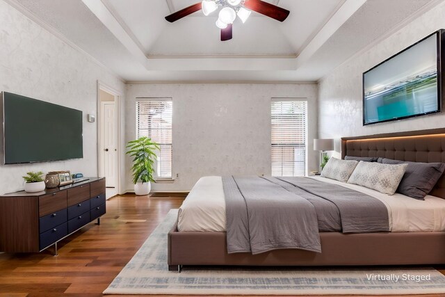 1504 Huron Trl, Plano, TX 75075 - bedroom with lofted ceiling, dark wood-style flooring, a tray ceiling, crown molding, and ceiling fan